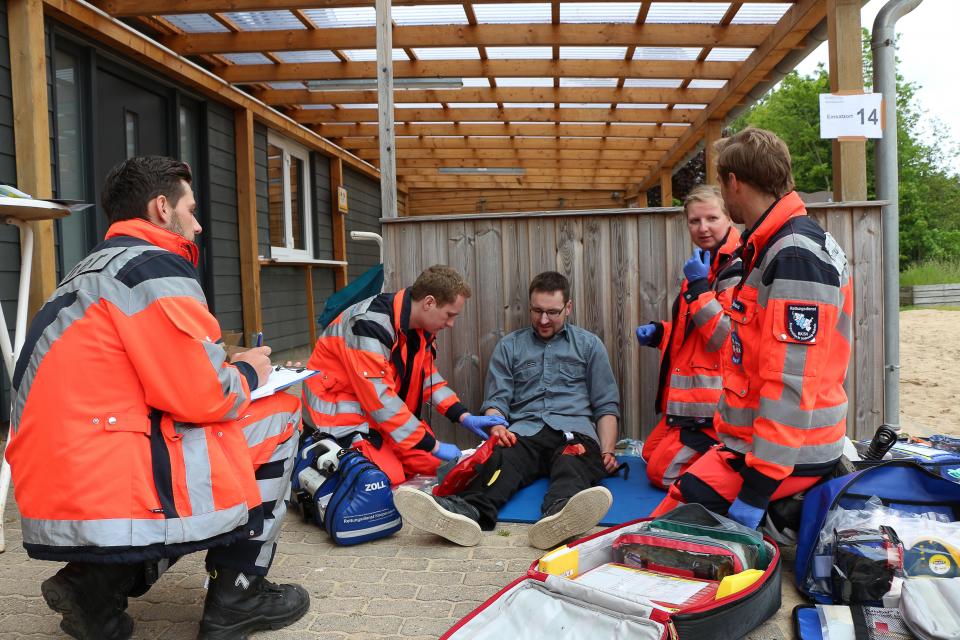 Angehende Notfallsanitäter versorgen eine Beinverletzung.